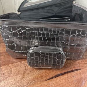 Silver crocodile-embossed crossbody bag and matching smaller case.